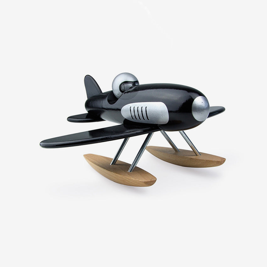 Model airplane with wooden floats on a white background